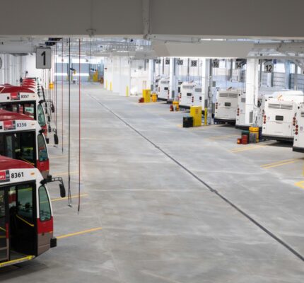 A row of Calgary Transit city buses in a garage