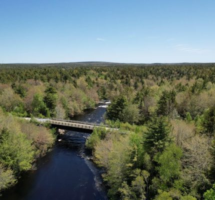 A bridge crosses the Mersey River under blue skies near the future site of a wind farm.