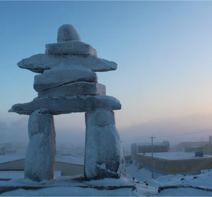 An inukshuk in front of the community of Arviat, Nunavut.