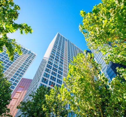 Commercial office building surrounded by green trees