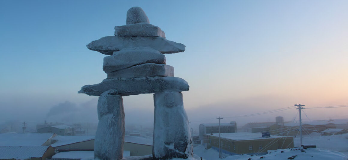 An inukshuk in front of the community of Arviat, Nunavut.