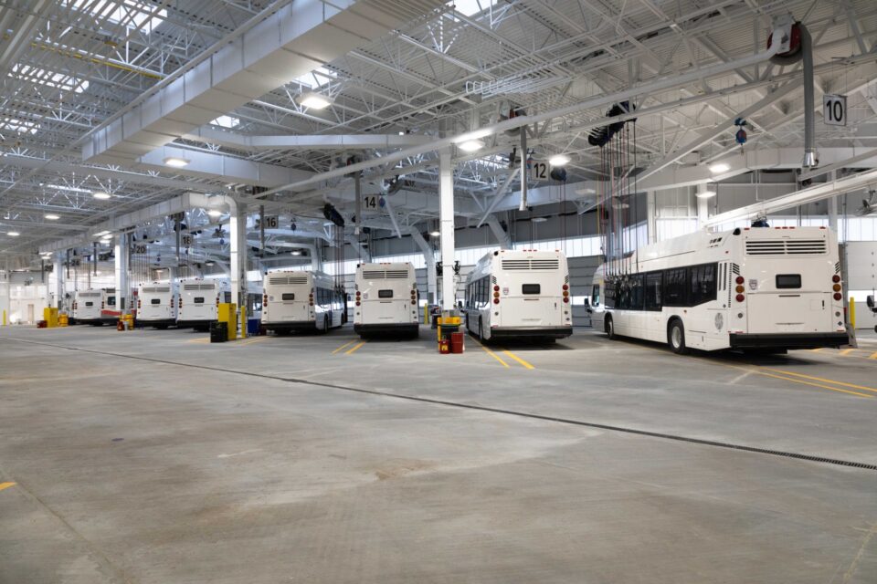 The backs of several Calgary Transit city buses in a garage