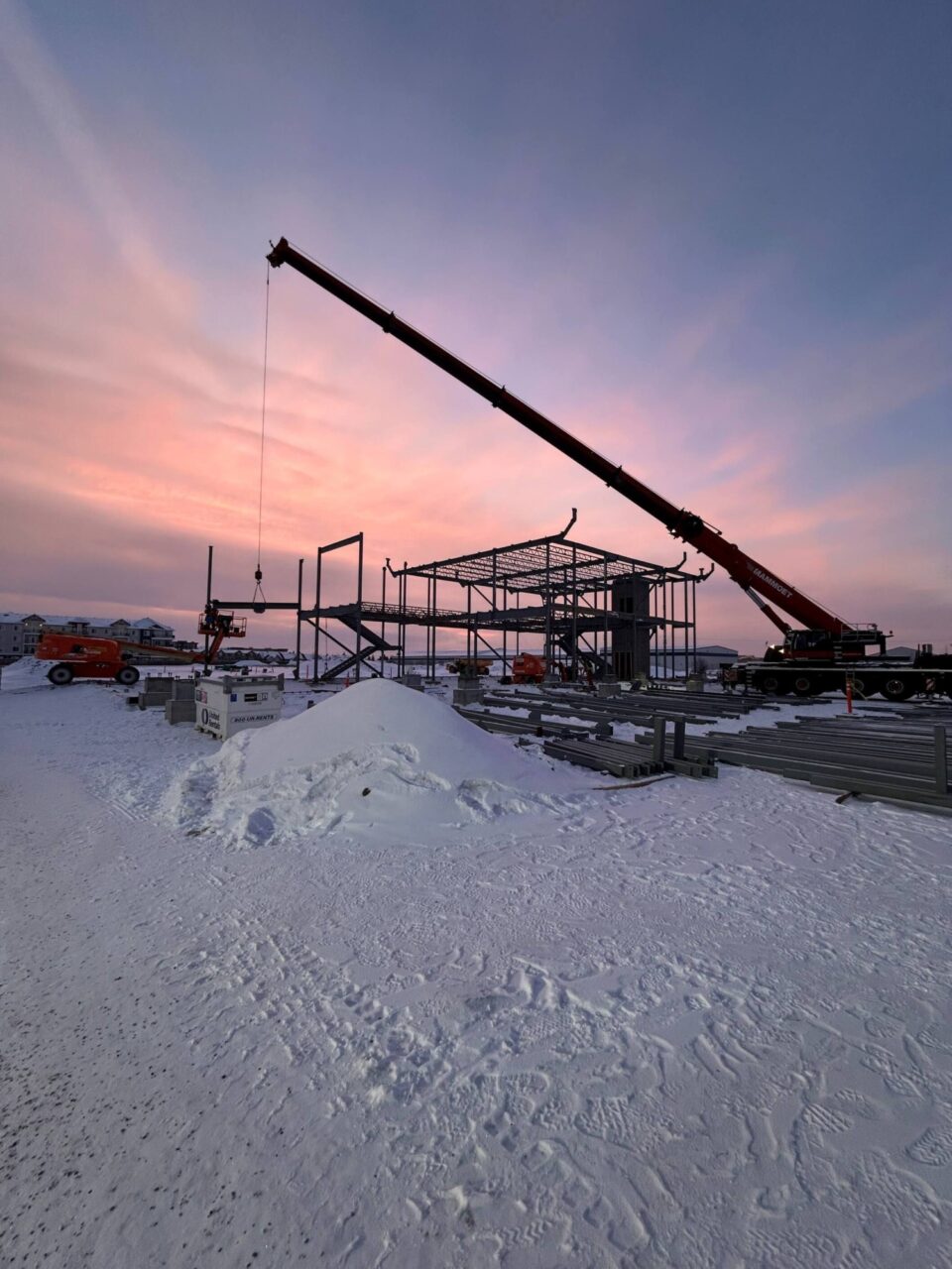 Charpente et grue sur un chantier enneigé, Première Nation de Doig River.