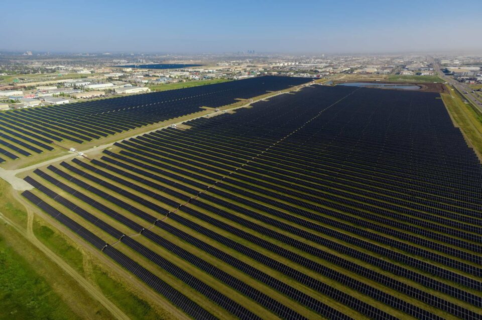 Solar panels – aerial view with city and sky in background