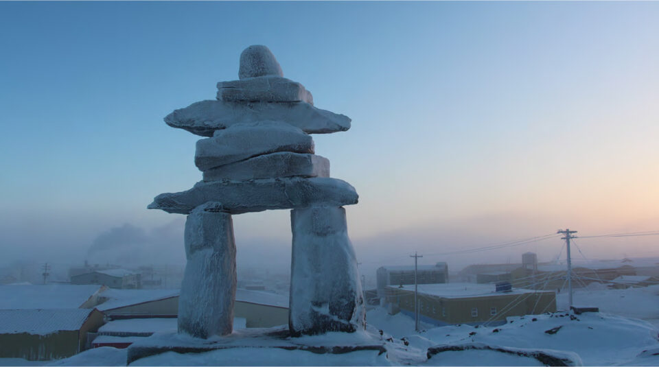 An inukshuk in front of the community of Arviat, Nunavut.