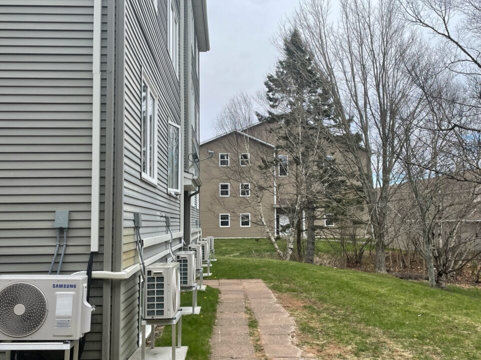 Side of grey student Housing building with air conditioners in Sackville, New Brunswick