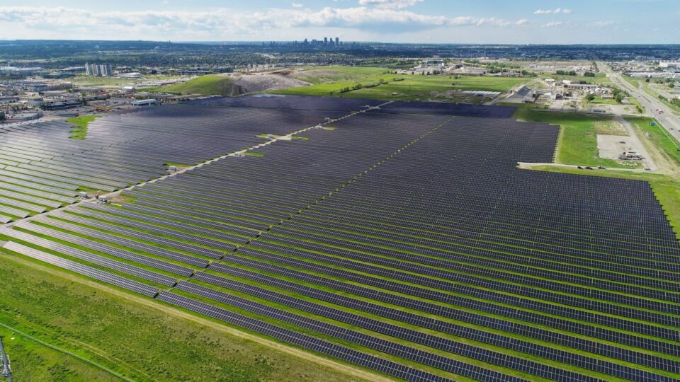 Solar panels – aerial view with city and sky in background