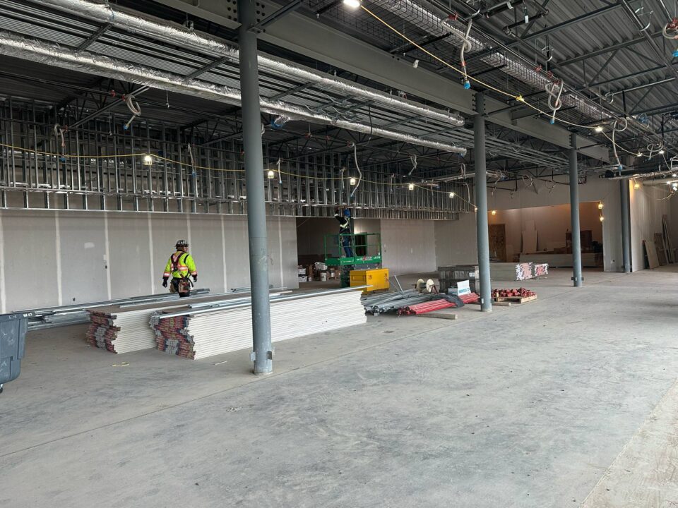 Indoor construction site of the Airport Thompson Terminal building with large open space.