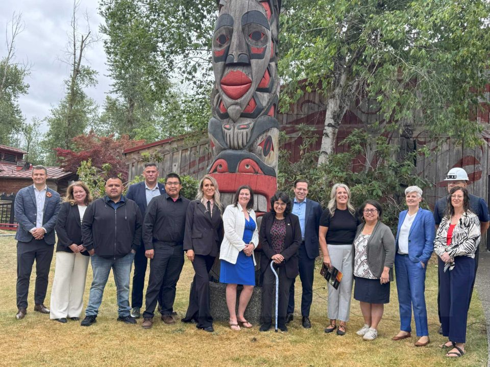 Rivers Edge partners and government officials in front of a totem pole