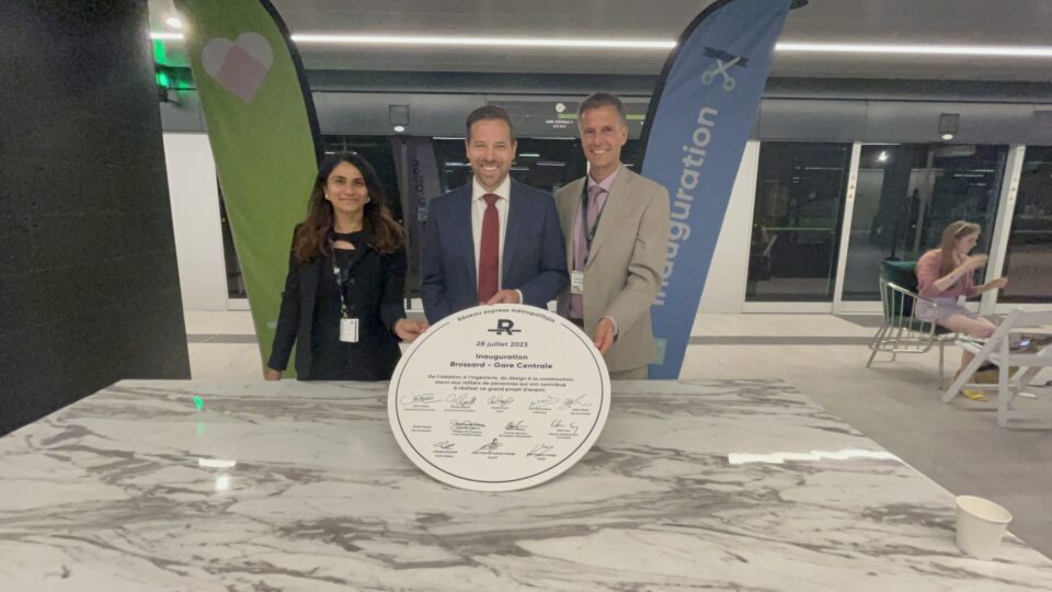CIB CEO Ehren Cory (centre) and directors Divya Shah and Philippe Raymond display a plaque signed by REM partners that will be posted in the Central Station terminal.